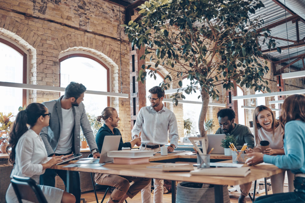 Group of young modern people in smart casual wear communicating